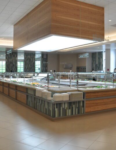 Modern cafeteria with food stations and spacious seating area.