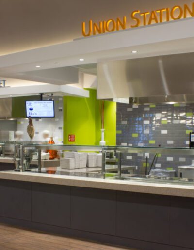 Modern food court counter with signage for union station and eastern market before opening hours.