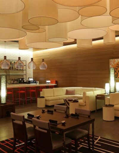 Modern hotel lounge with circular lighting fixtures and contemporary furniture.