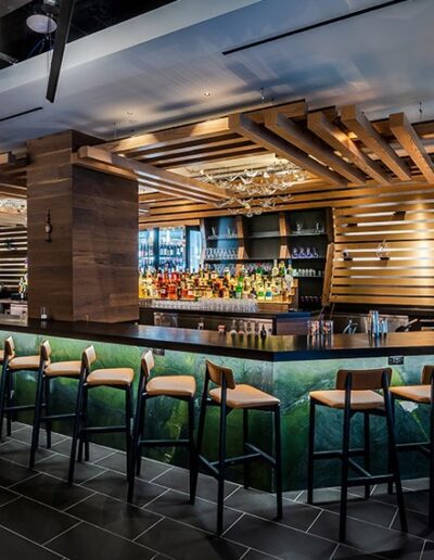 Modern bar interior with sleek wooden accents and contemporary seating.